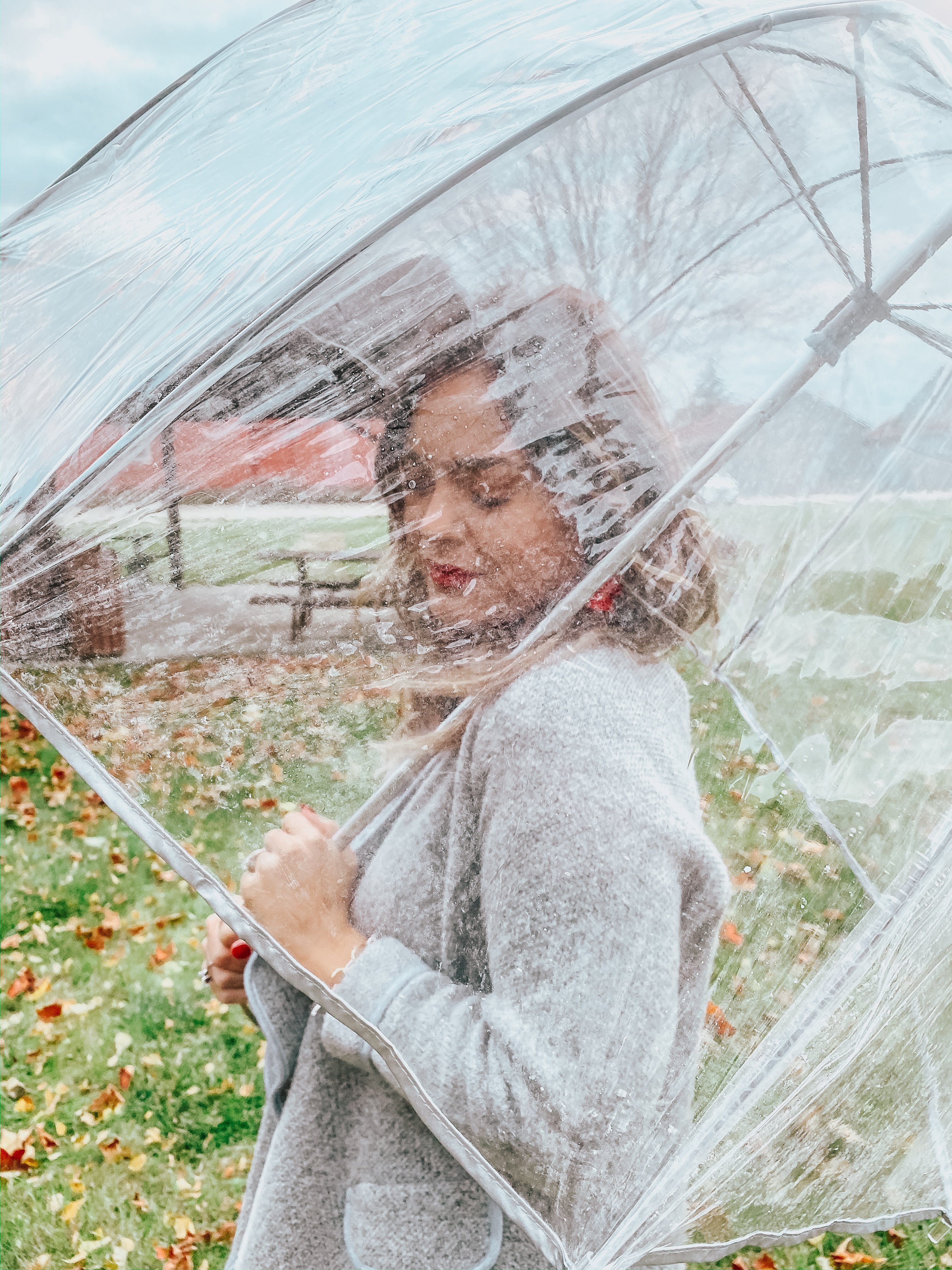 A woman sitting under an umbrella photo – Free Person Image on Unsplash